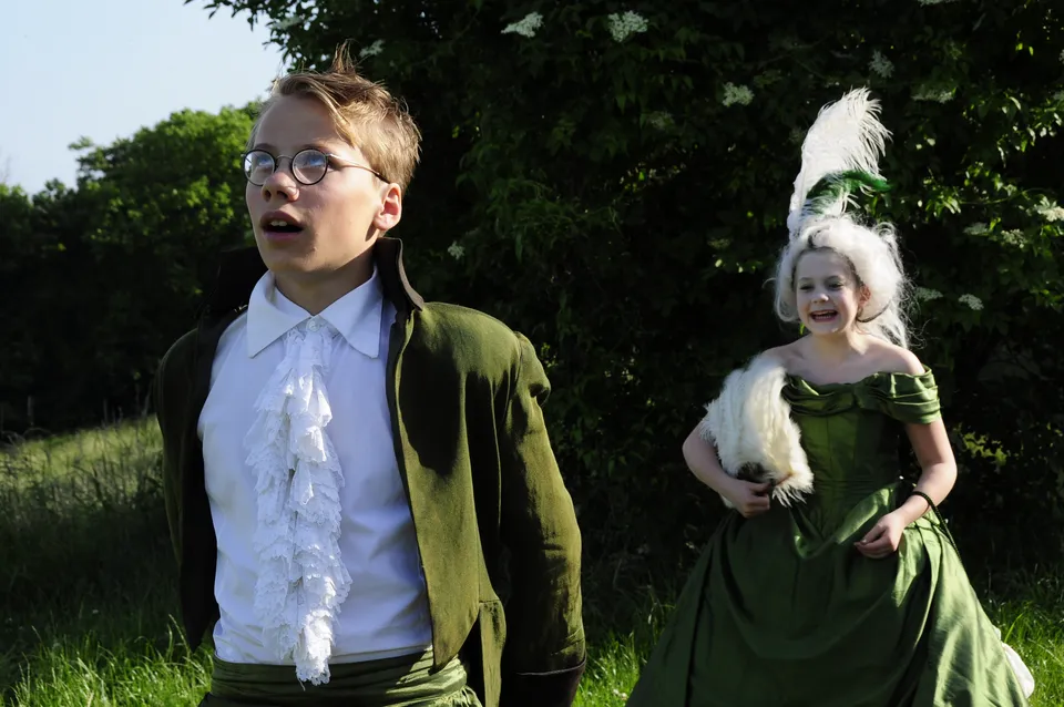 Two teenagers in costume performing outdoors